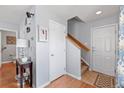 Bright entryway features hardwood floors, a staircase, and a conveniently located half bath at 14300 Waterside Ln # J4, Broomfield, CO 80023