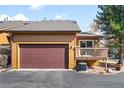 A spacious attached garage with a large door and adjacent deck enhances this home's functionality at 11945 W 66Th Pl # A, Arvada, CO 80004