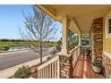 Cozy front porch offering scenic views and a relaxing outdoor space with stone and wood accents at 2872 Dreamcatcher Loop, Castle Rock, CO 80109