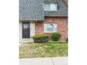 Close up view of the brick front exterior of this townhome featuring a small front yard at 15107 E Wesley Ave, Aurora, CO 80014