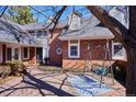 Outdoor patio featuring a decorative swing and blue patterned outdoor rug surrounded by a well maintained brick exterior at 210 S High St, Denver, CO 80209