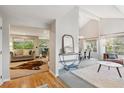 Inviting entryway flows into a sunlit living space and dining area with vaulted ceilings and stylish decor at 14072 W Alaska Dr, Lakewood, CO 80228