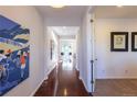 Inviting hallway with hardwood floors leading to a bright dining area at 651 Tiger Lily Way, Highlands Ranch, CO 80126