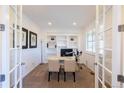 Bright home office with french doors, custom built-ins, and natural light at 651 Tiger Lily Way, Highlands Ranch, CO 80126