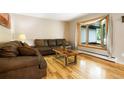Cozy living room with large window, hardwood floors, and comfortable seating at 8595 S Yarrow St, Littleton, CO 80128