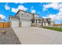 Two-story home with gray siding, three-car garage, and landscaped lawn at 4207 Sandstone Dr, Mead, CO 80504