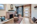 Inviting living room features a brick fireplace, hardwood floors, and lots of natural light at 2436 W 34Th Ave, Denver, CO 80211