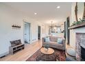 Bright living room with hardwood floors, fireplace, and neutral decor that opens to dining area at 2436 W 34Th Ave, Denver, CO 80211