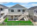 Back exterior of a lovely two-story home featuring a spacious deck, steps and a fenced yard at 2143 Peralta Loop, Castle Rock, CO 80104