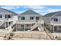 Back exterior of a lovely two-story home featuring a spacious deck, steps and a fenced yard at 2143 Peralta Loop, Castle Rock, CO 80104