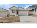 Charming home featuring stone accents, a covered porch, and an attached two-car garage at 2143 Peralta Loop, Castle Rock, CO 80104