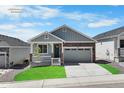 Charming single-Gathering home with stone accents, a two-car garage, and green lawn at 2143 Peralta Loop, Castle Rock, CO 80104