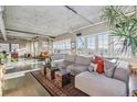 Stylish living room with large windows, hardwood floors, and a comfortable sofa arrangement at 1499 Blake St # 6K, Denver, CO 80202