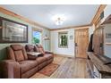 Inviting living room with hardwood floors, comfortable seating, and well-lit windows providing ample natural light at 4716 Broadway, Denver, CO 80216