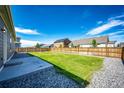 Spacious backyard with a concrete patio area perfect for outdoor dining and entertaining at 56459 E 23Rd Pl, Strasburg, CO 80136