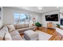 Bright living room featuring hardwood floors, large windows, and a comfortable sectional sofa at 3604 Collins St, Castle Rock, CO 80108