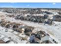 Aerial view of a residential neighborhood with houses and streets covered in snow at 1018 Mcmurdo Cir, Castle Rock, CO 80108