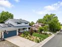 Inviting two-story home boasts a well-kept yard, solar panels, and a convenient two-car garage at 915 Mercury Cir, Littleton, CO 80124