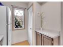 Bright kitchen features a functional layout, white appliances, and a charming window at 2627 E Nichols Cir, Centennial, CO 80122