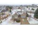 Aerial view of a stone home with solar panels on a snowy lot at 1752 Peninsula Cir, Castle Rock, CO 80104