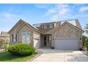 Charming stone-accented home with attached garages and solar panels at 1752 Peninsula Cir, Castle Rock, CO 80104