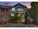 Attractive two-story building featuring brick and blue siding with balconies at sunset at 2672 S Cathay Way # 304, Aurora, CO 80013