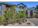 Attractive two-story building with brick and blue siding, nicely landscaped at 2672 S Cathay Way # 304, Aurora, CO 80013