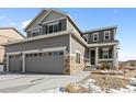 Beautiful two-story house with stone accents, a covered front porch, and manicured front yard at 2924 Echo Park Dr, Castle Rock, CO 80104