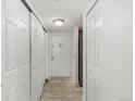 Bright hallway with tiled floors and ample closet space at 14100 E Temple Dr # W04, Aurora, CO 80015