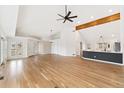 Open concept living room featuring hardwood floors, high ceilings, and a modern kitchen with island seating at 1904 S Union Pl, Lakewood, CO 80228
