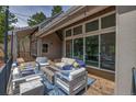 Relaxing covered porch offers ample seating with a fire pit and string lights at 3640 Summertime Ct, Monument, CO 80132