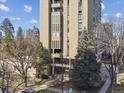 View of the exterior of the building, with tall trees surrounding the property at 1111 Race St # 3A, Denver, CO 80206
