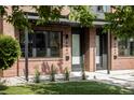 Close up of the exterior of a brick townhome with modern black window accents at 4481 Raleigh St, Denver, CO 80211
