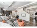 Open concept living space with a modern kitchen, comfortable seating and natural light at 18366 E 102Nd Pl, Commerce City, CO 80022