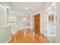 Inviting home foyer with hardwood flooring and a view of the dining and living room at 14032 E Chenango Dr, Aurora, CO 80015