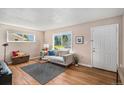 Inviting living room with stylish decor, hardwood floors, and plenty of natural light at 2465 W Mosier Pl, Denver, CO 80223