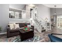 Comfortable living room featuring a sofa, stairs and stylish decor at 3082 W 107Th Pl # H, Westminster, CO 80031