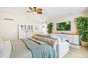 Comfortable bedroom featuring a ceiling fan, lush plants, and built-in storage cabinets at 3532 Springbriar Dr, Castle Rock, CO 80109