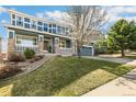 Attractive blue two-story home featuring a covered front porch and well-maintained landscaping at 3532 Springbriar Dr, Castle Rock, CO 80109