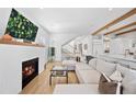 Bright living room with fireplace, hardwood floors, large sectional, and open layout at 652 S Race St, Denver, CO 80209