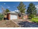 Charming brick home with attached garage, mature trees, and well-maintained landscaping at 500 Fulton St, Aurora, CO 80010