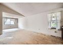 Bright living room with large windows and neutral walls at 11029 W 65Th Way, Arvada, CO 80004