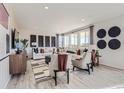 Bright living room featuring modern furniture, large windows, and stylish decor creating an inviting atmosphere at 14147 Bunny Hop Ln, Parker, CO 80134
