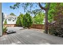 Large wooden deck in a private, landscaped backyard, perfect for outdoor entertaining at 8056 Meadowdale Sq, Niwot, CO 80503