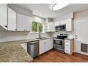 Modern kitchen featuring stainless steel appliances, granite countertops, and ample storage at 8056 Meadowdale Sq, Niwot, CO 80503