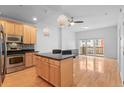 Bright open-concept living space featuring hardwood floors, island kitchen, and private balcony at 1950 N Logan St # 601, Denver, CO 80203