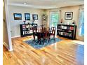 Elegant dining room with hardwood floors, a table set, and natural light from the windows at 4303 S Yank St, Morrison, CO 80465