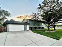 Charming two-story home with a well-maintained lawn and a two car garage at 4303 S Yank St, Morrison, CO 80465