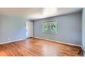 Bright living room featuring gleaming hardwood floors, neutral paint, and natural light from a large window at 2497 S Race St, Denver, CO 80210