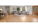 Bright living room with wood floors, two sofas, large windows and a wooden door at 25 High St, Palmer Lake, CO 80133